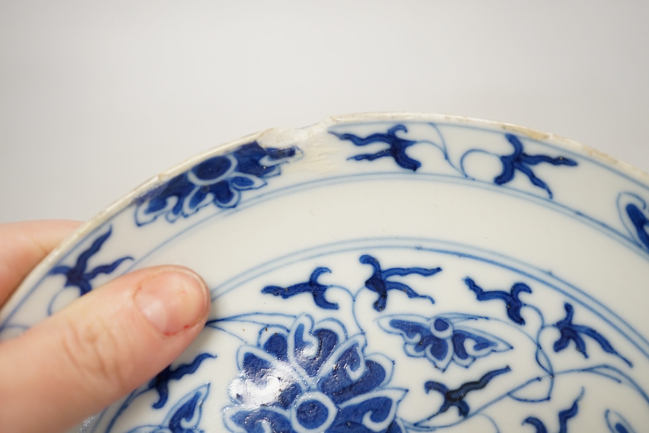 A Chinese underglaze copper red ‘herder and goats’ vase, Kangxi six character mark but Republic period and a Chinese blue and white lotus stem dish, six character Guangxu mark and period, both damaged